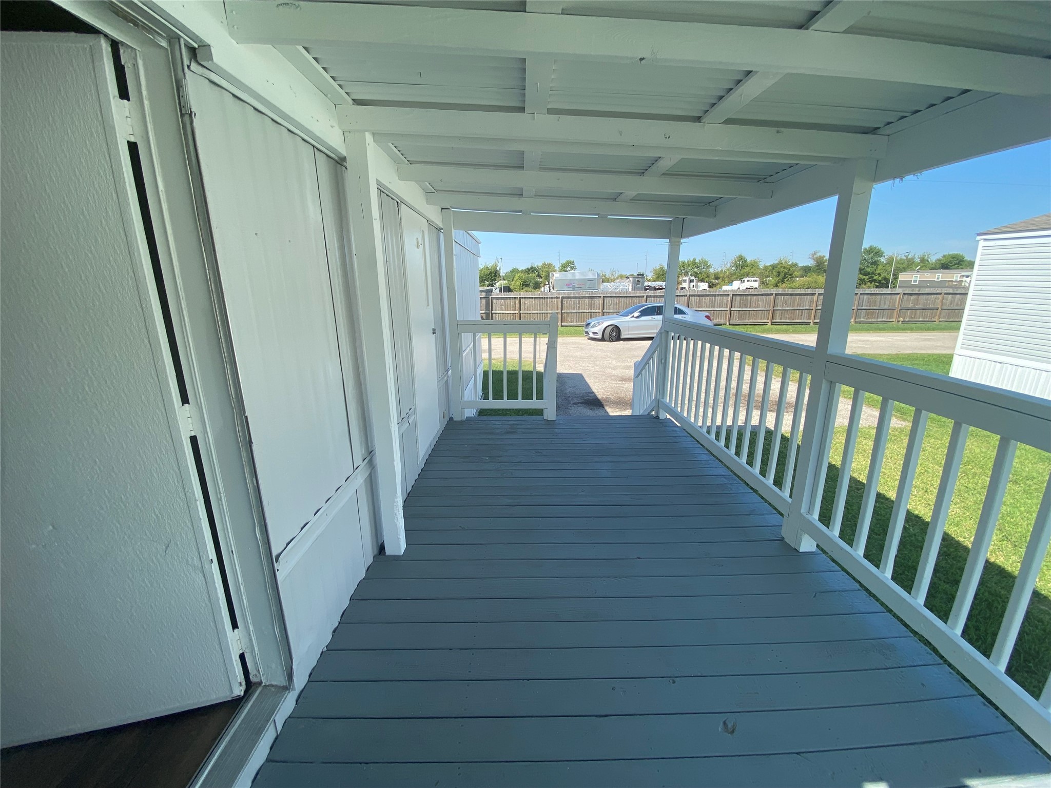 2021 North Battlebell Road, Unit 28 Highlands, TX 77562 - Photo 4 of 8 a view of a porch with wooden floor