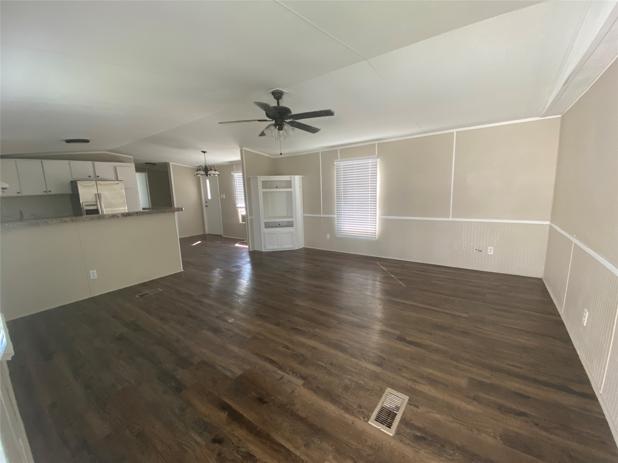 2021 North Battlebell Road, Unit 28 Highlands, TX 77562 - Photo 5 of 8 a view of a livingroom with wooden floor and a ceiling fan