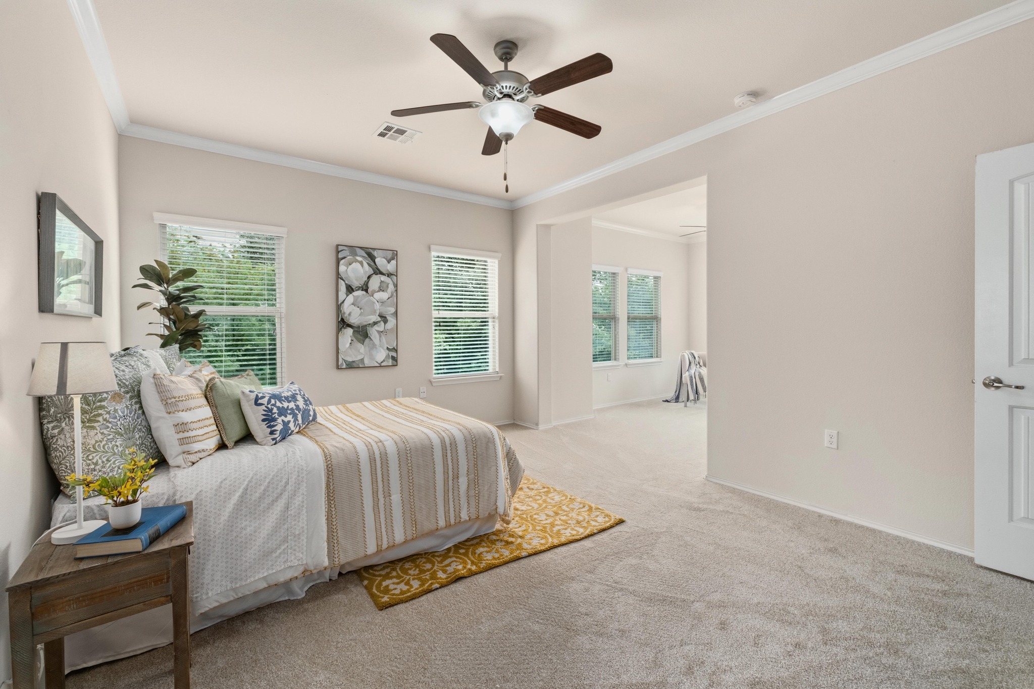 10124 Pinnacle Crest Loop Austin, TX 78747 - Photo 15 of 31 Spacious room with plush carpeting, crown molding, and a ceiling fan with integrated lighting