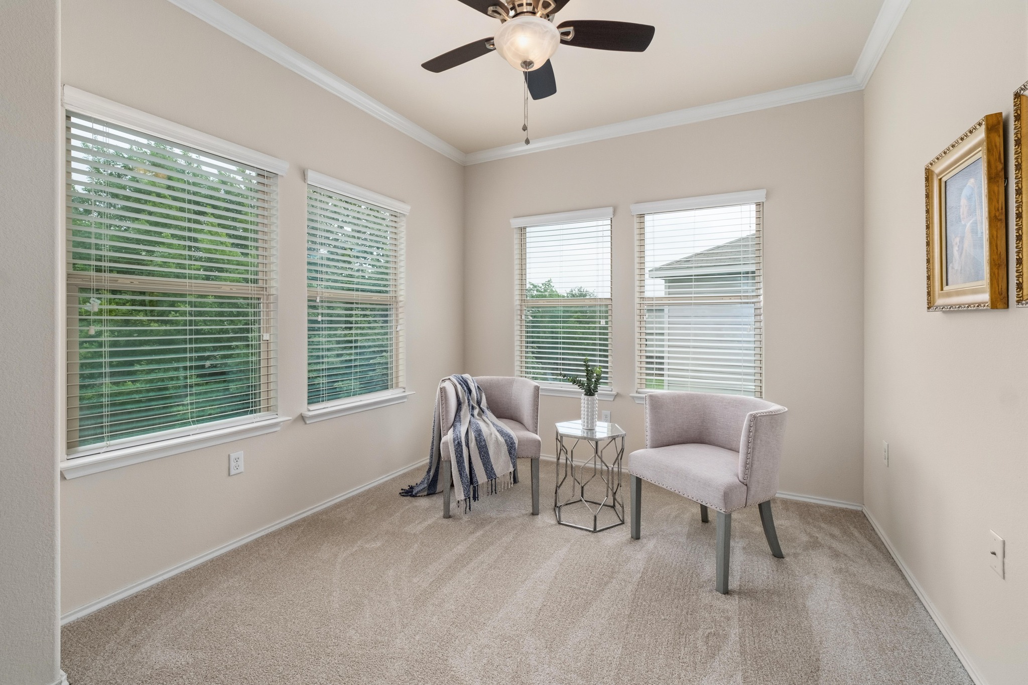 10124 Pinnacle Crest Loop Austin, TX 78747 - Photo 16 of 31 Room featuring multiple windows with blinds, crown molding, and a ceiling fan