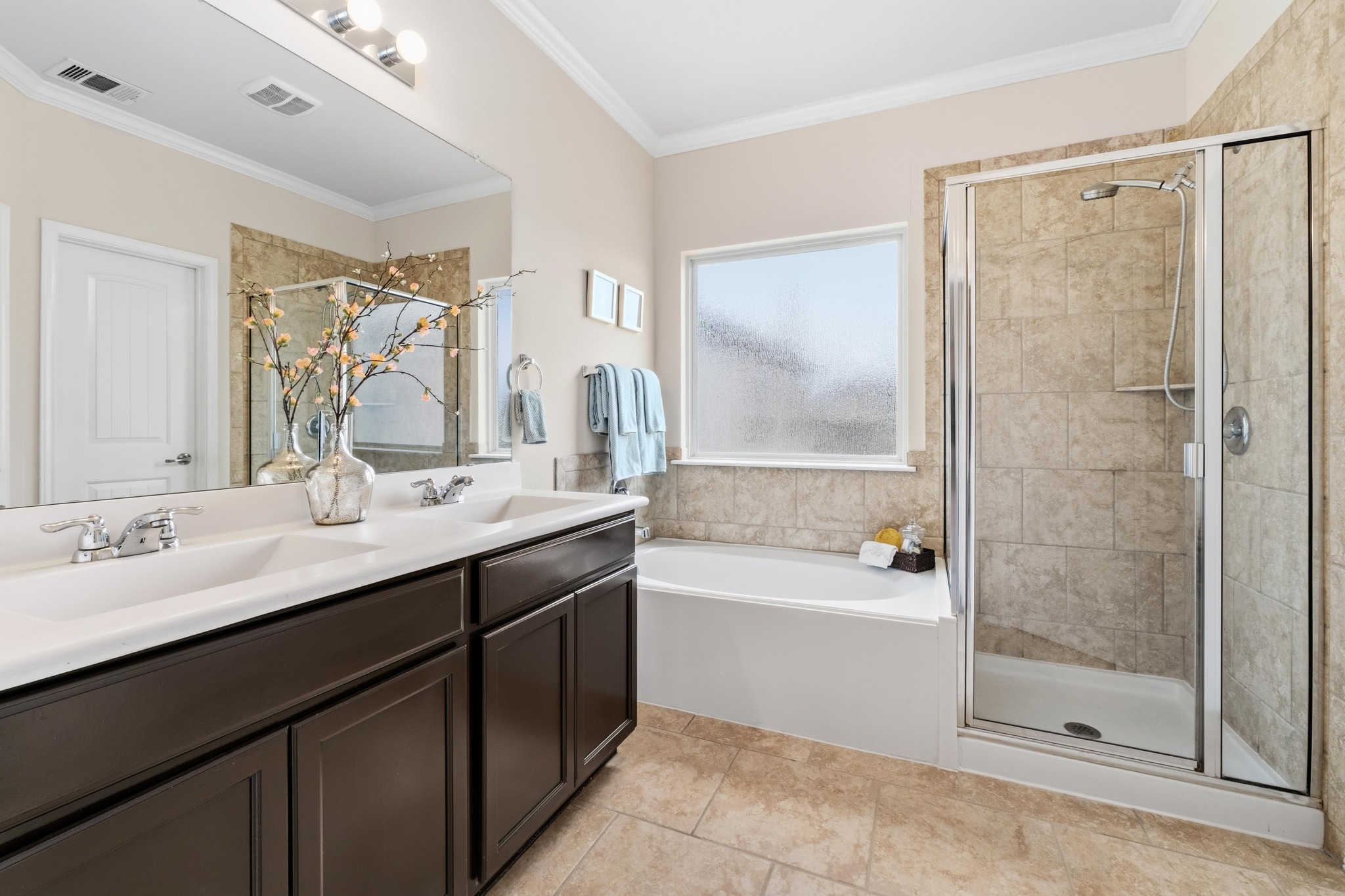 10124 Pinnacle Crest Loop Austin, TX 78747 - Photo 17 of 31 Dual vanity with undermount sinks and chrome fixtures, framed by a large mirror