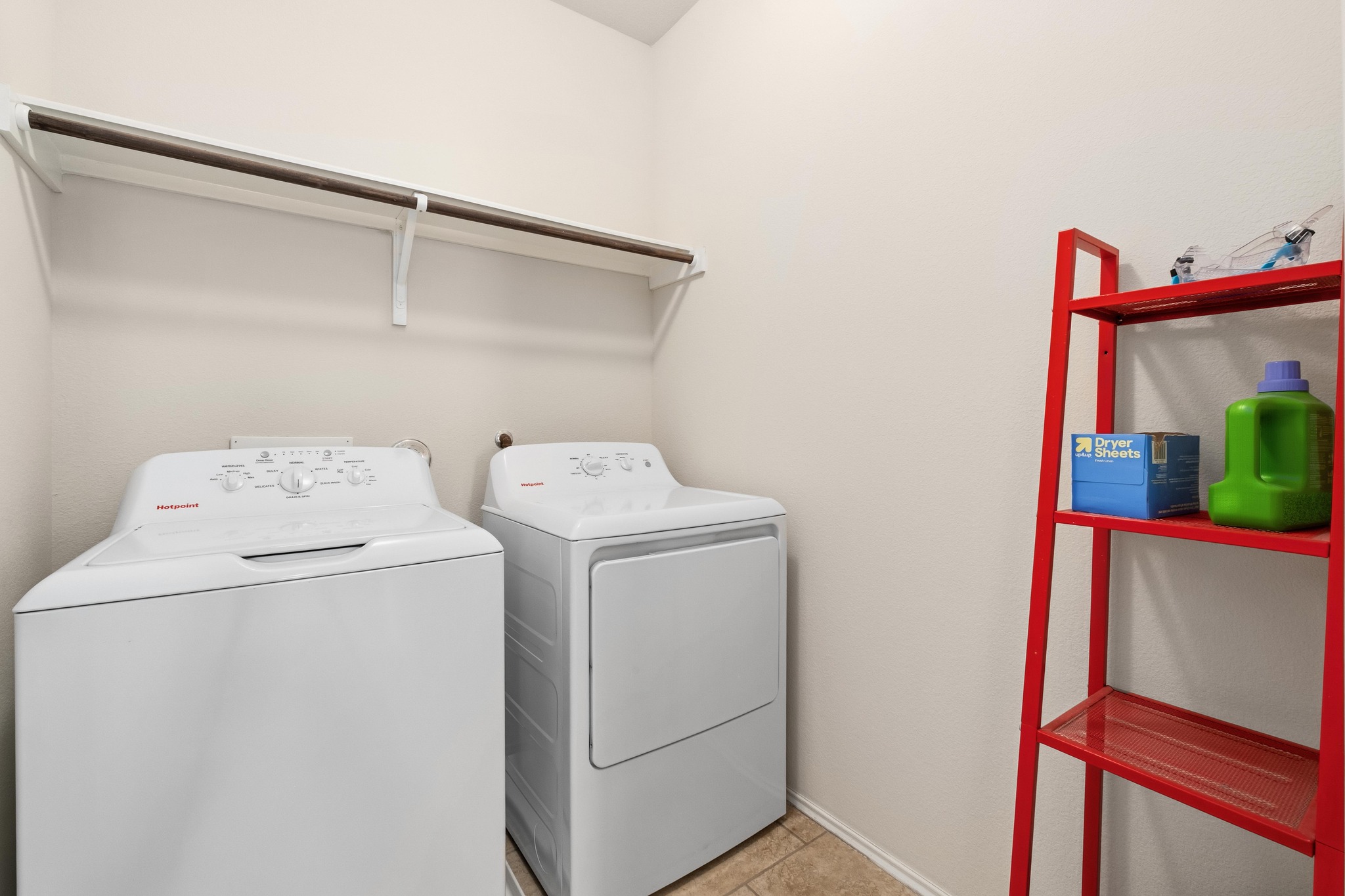 10124 Pinnacle Crest Loop Austin, TX 78747 - Photo 26 of 31 Laundry area featuring a built-in shelf with hanging rod and tiled flooring