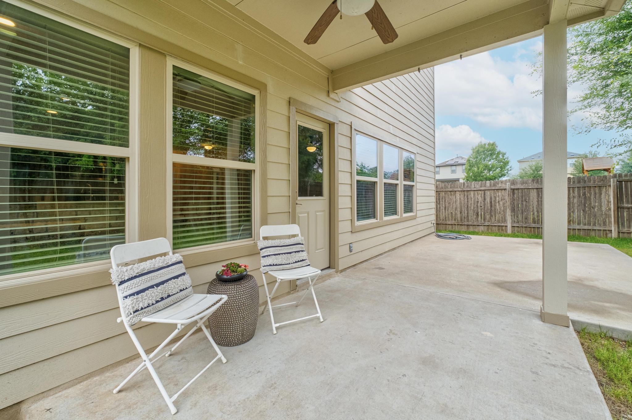 10124 Pinnacle Crest Loop Austin, TX 78747 - Photo 31 of 31 Expansive covered patio featuring a concrete slab, ceiling fan, and direct access to the interior through a glass-paneled door
