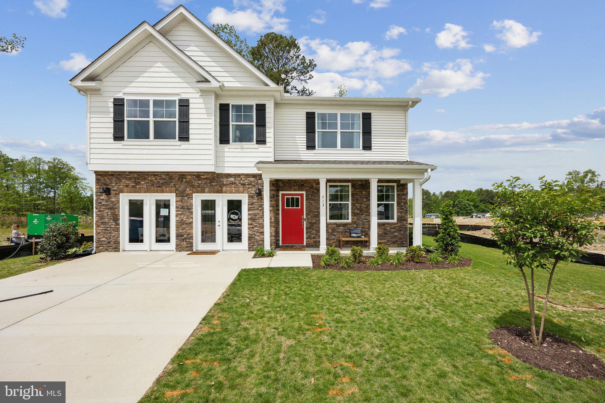 a front view of a house with a yard and porch
