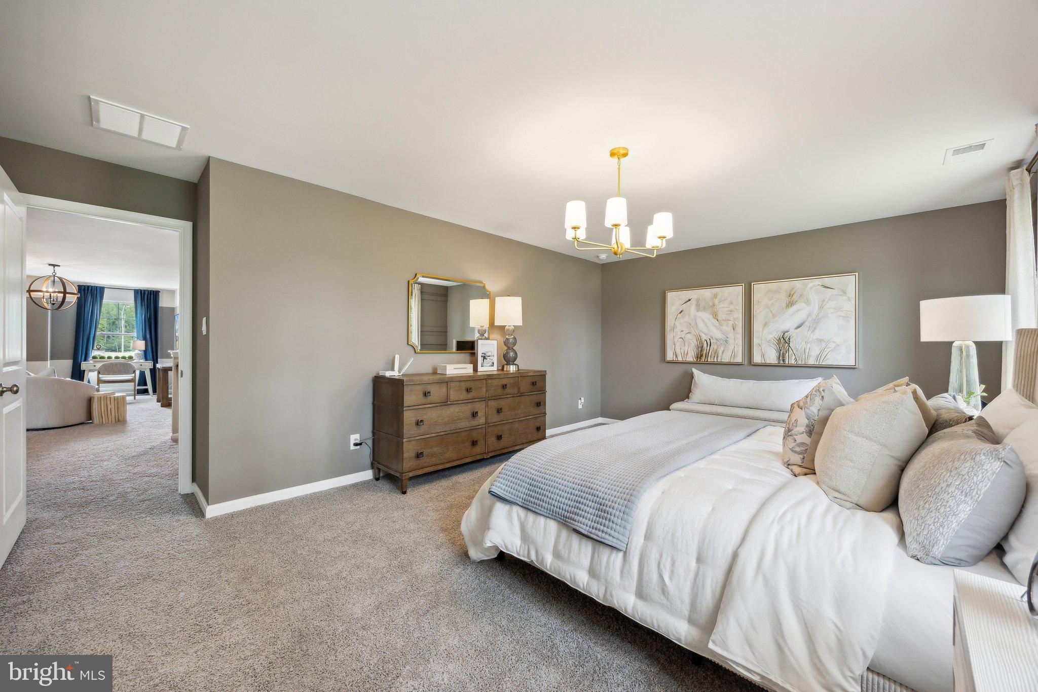 6292 Sterling Way Ruther Glen, VA 22546 - Photo 26 of 31 a bedroom with a bed and a chandelier