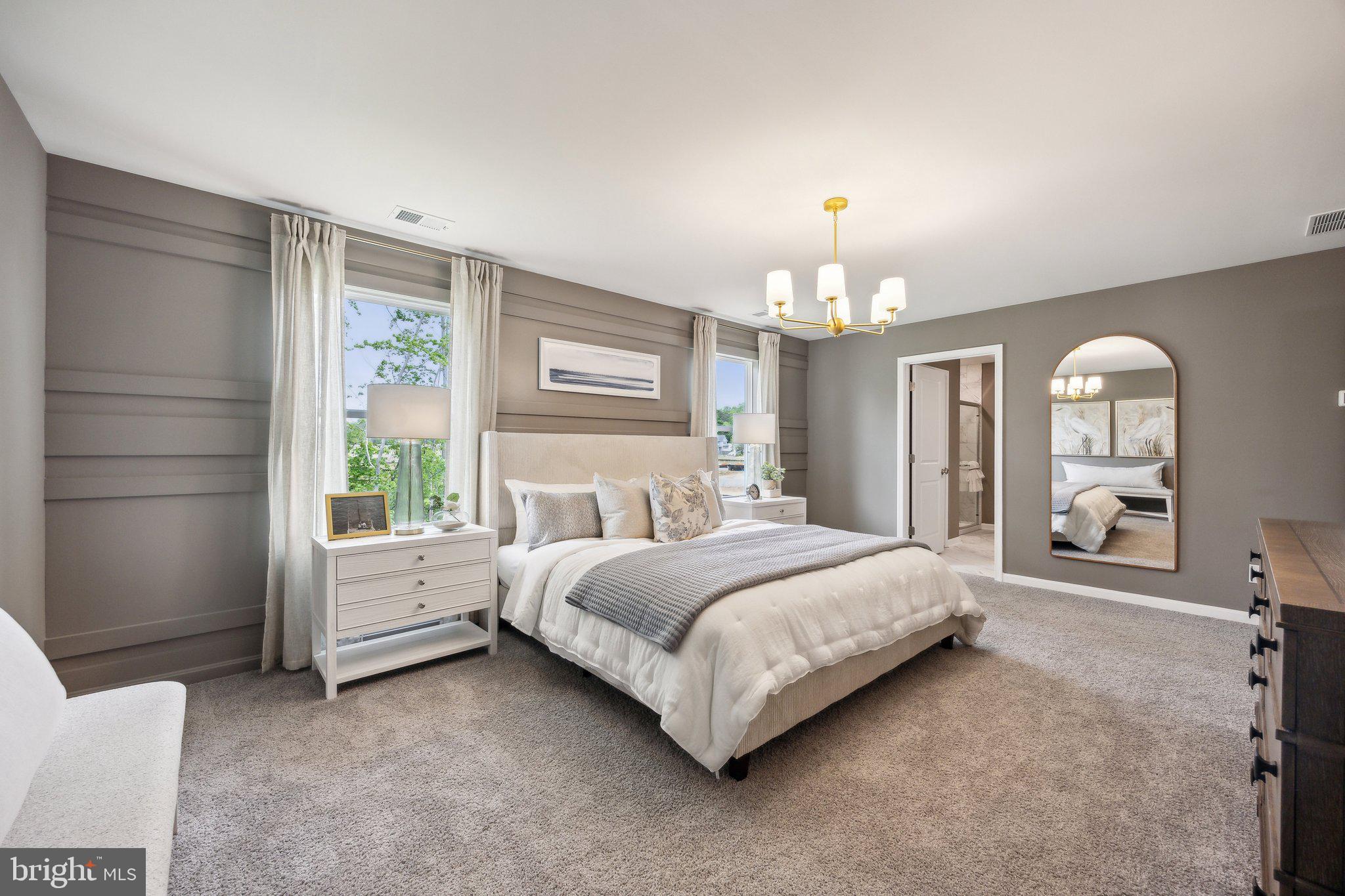 6292 Sterling Way Ruther Glen, VA 22546 - Photo 27 of 31 a spacious bedroom with a bed a chandelier and large window