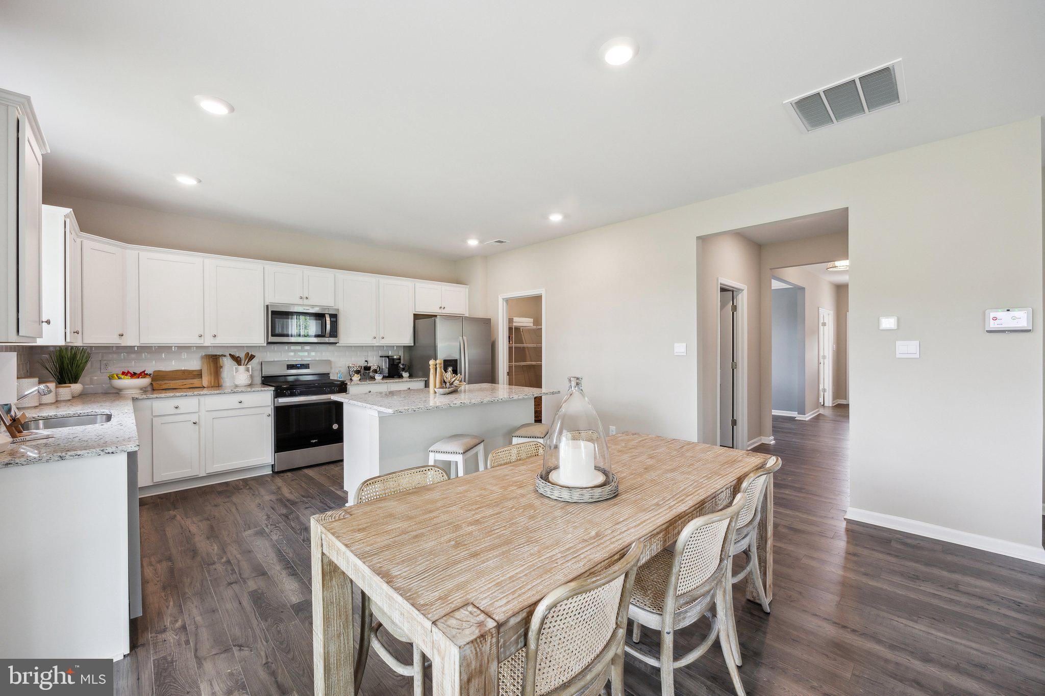 6292 Sterling Way Ruther Glen, VA 22546 - Photo 8 of 31 a kitchen with a table and chairs in it