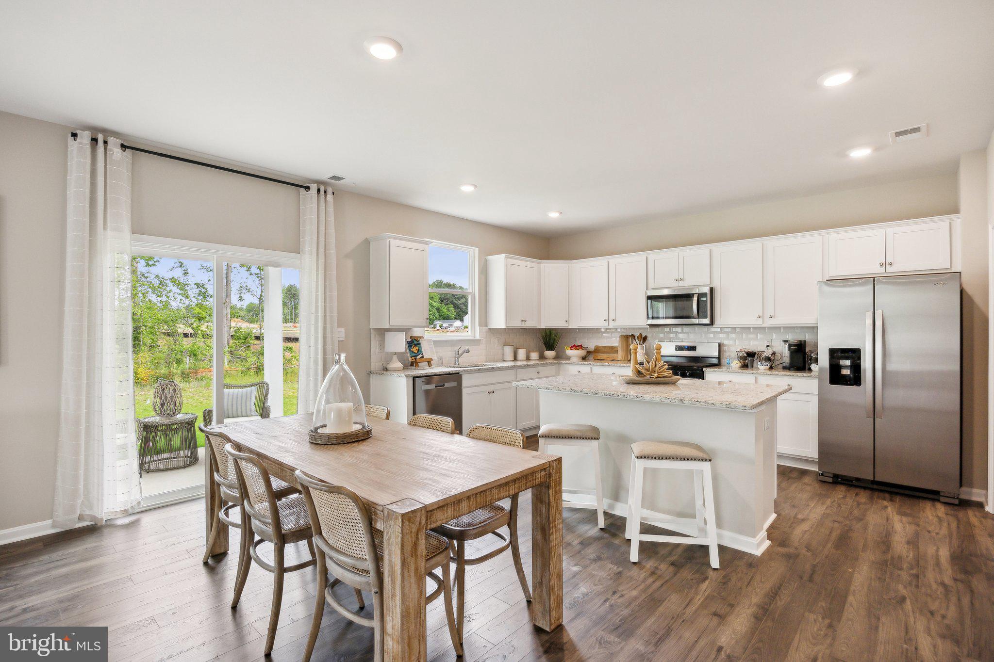 6292 Sterling Way Ruther Glen, VA 22546 - Photo 9 of 31 a kitchen with a table chairs refrigerator and cabinets