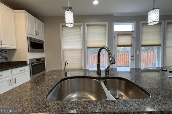 a kitchen with a sink cabinets and window