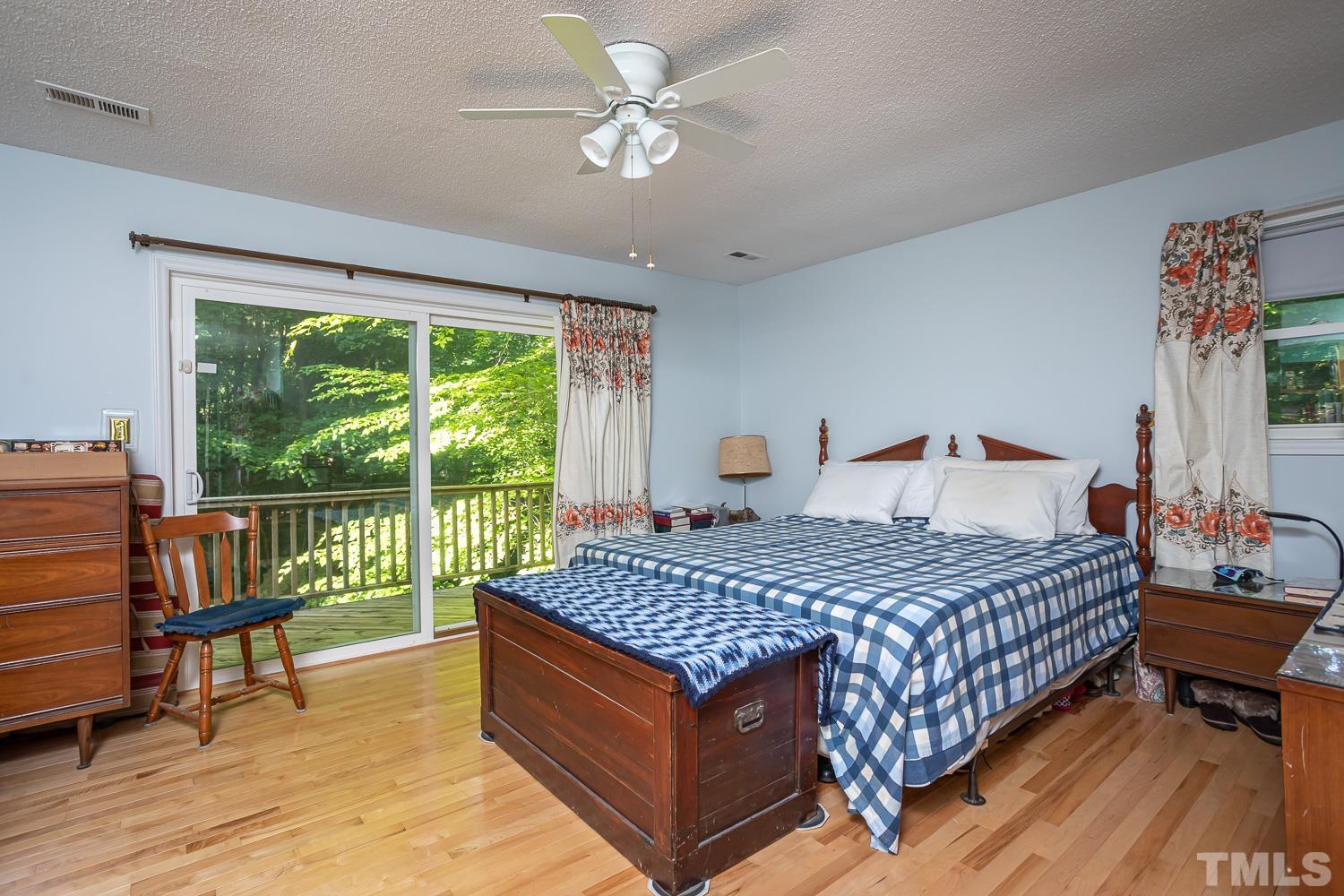 14401 Possum Track Road Raleigh, NC 27614 - Photo 12 of 30 a bedroom with a bed and a large window