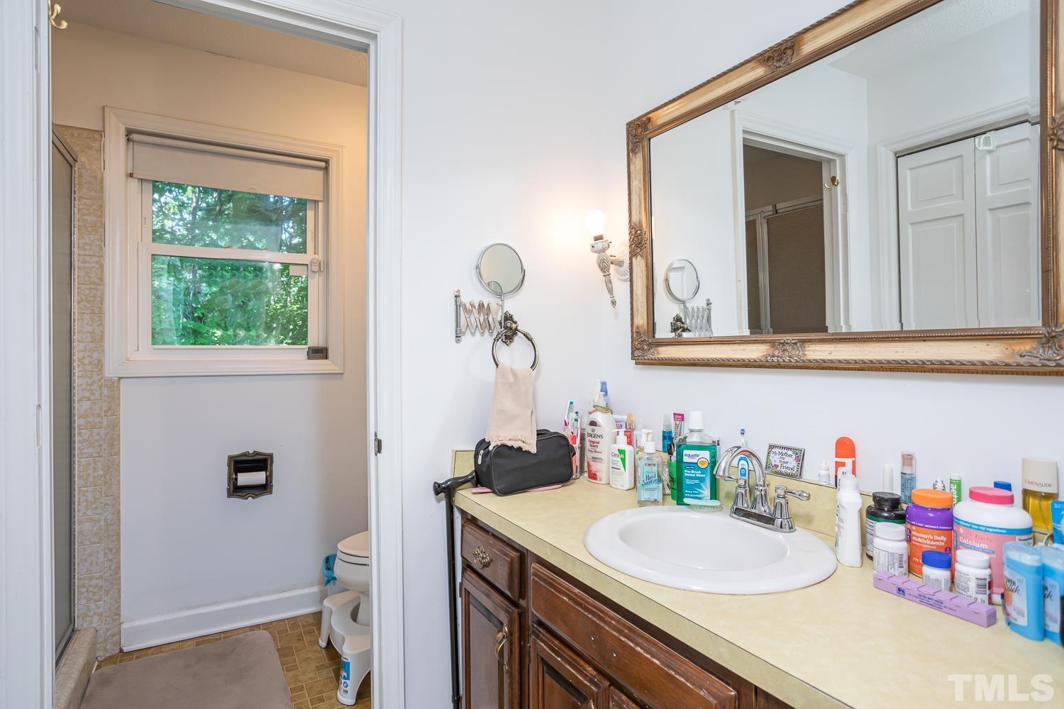 14401 Possum Track Road Raleigh, NC 27614 - Photo 13 of 30 a bathroom with a sink and a mirror