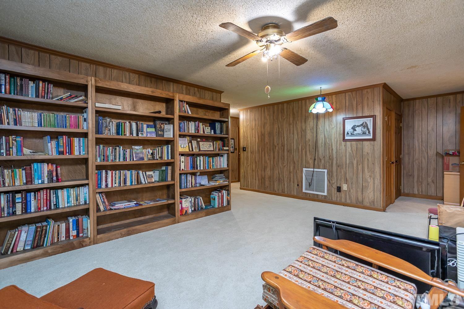 14401 Possum Track Road Raleigh, NC 27614 - Photo 17 of 30 a living room with furniture and a book shelf