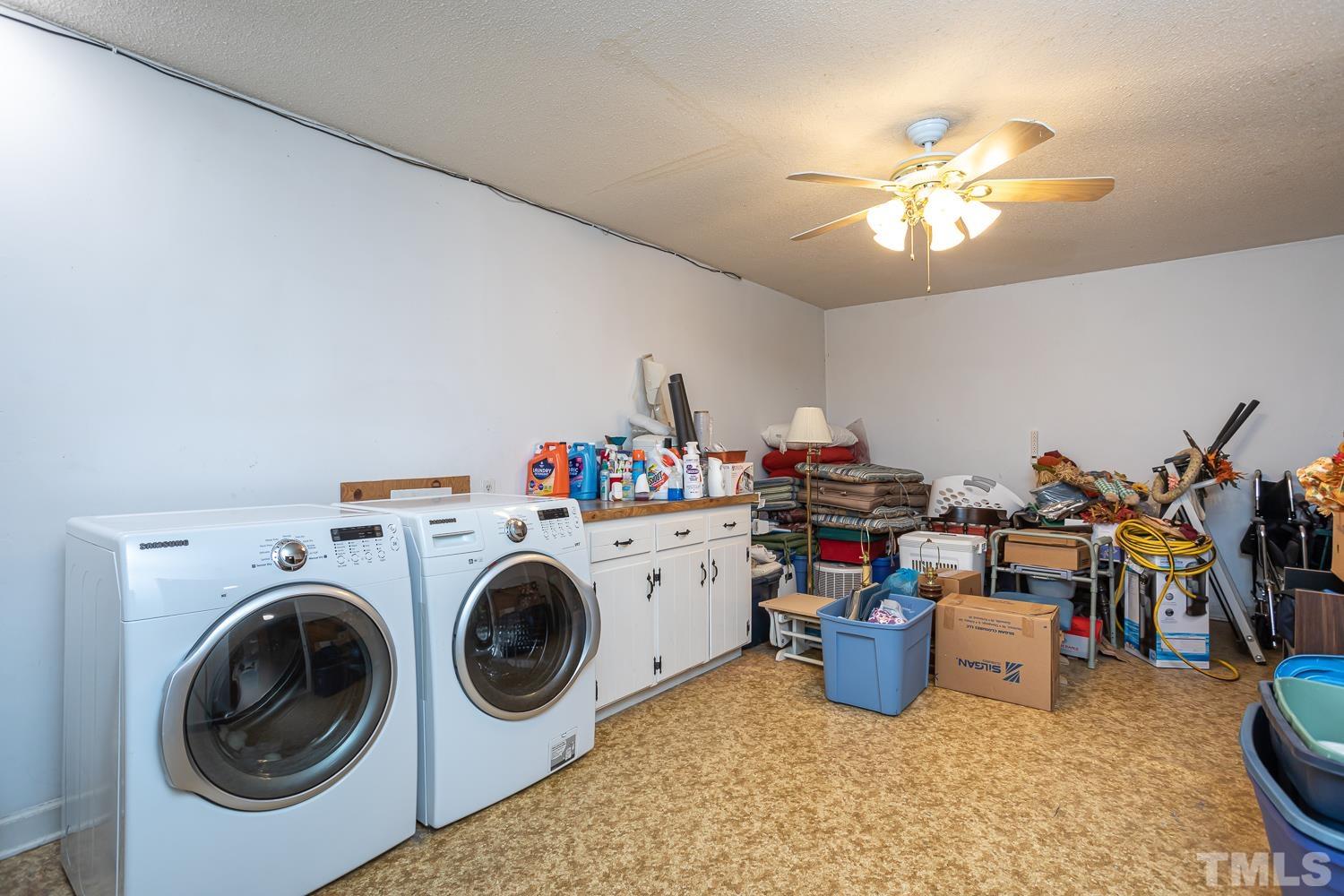 14401 Possum Track Road Raleigh, NC 27614 - Photo 19 of 30 a view of a storage & utility room with washer and dryer