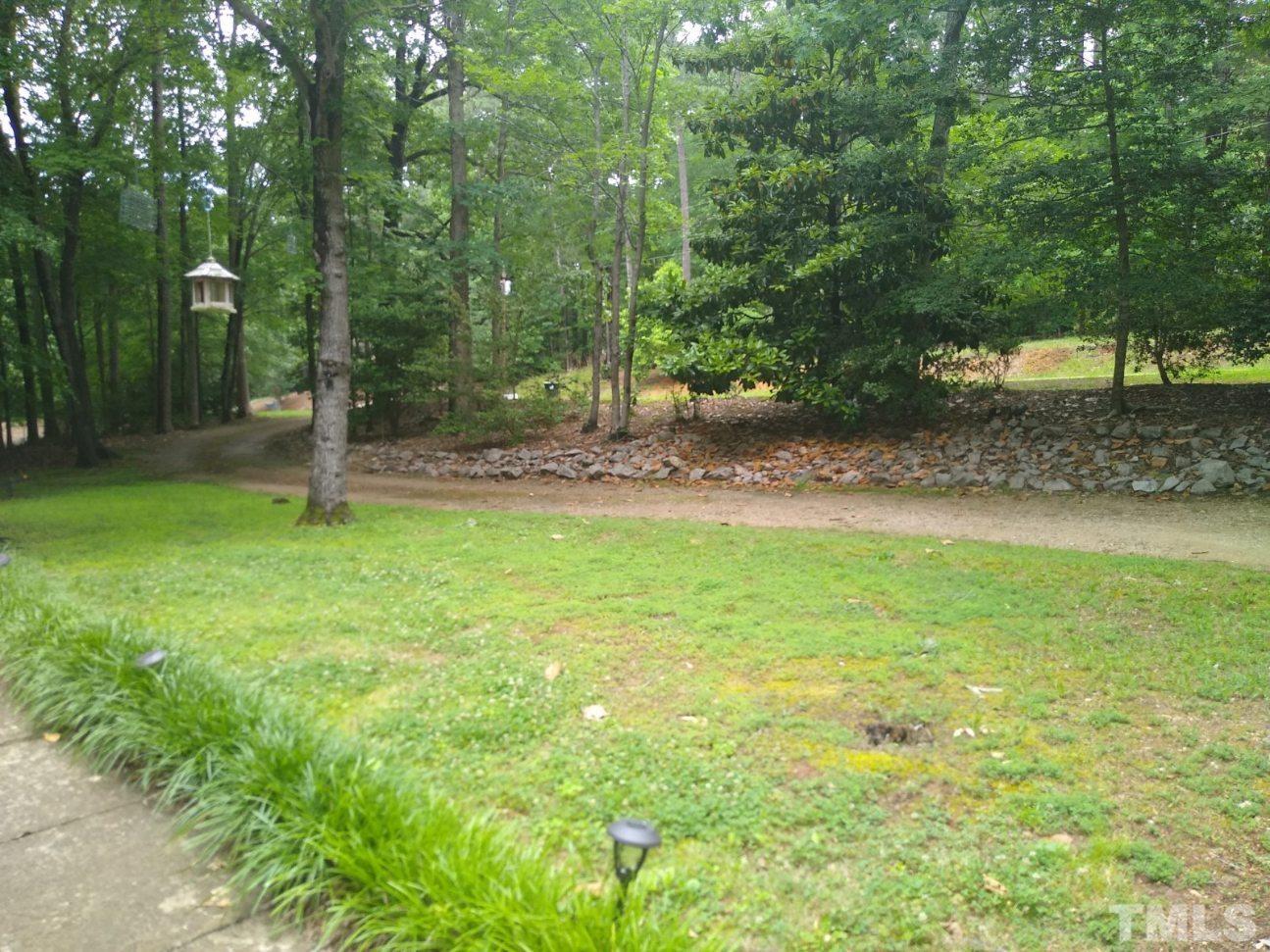 14401 Possum Track Road Raleigh, NC 27614 - Photo 4 of 30 a backyard of a house with lots of green space