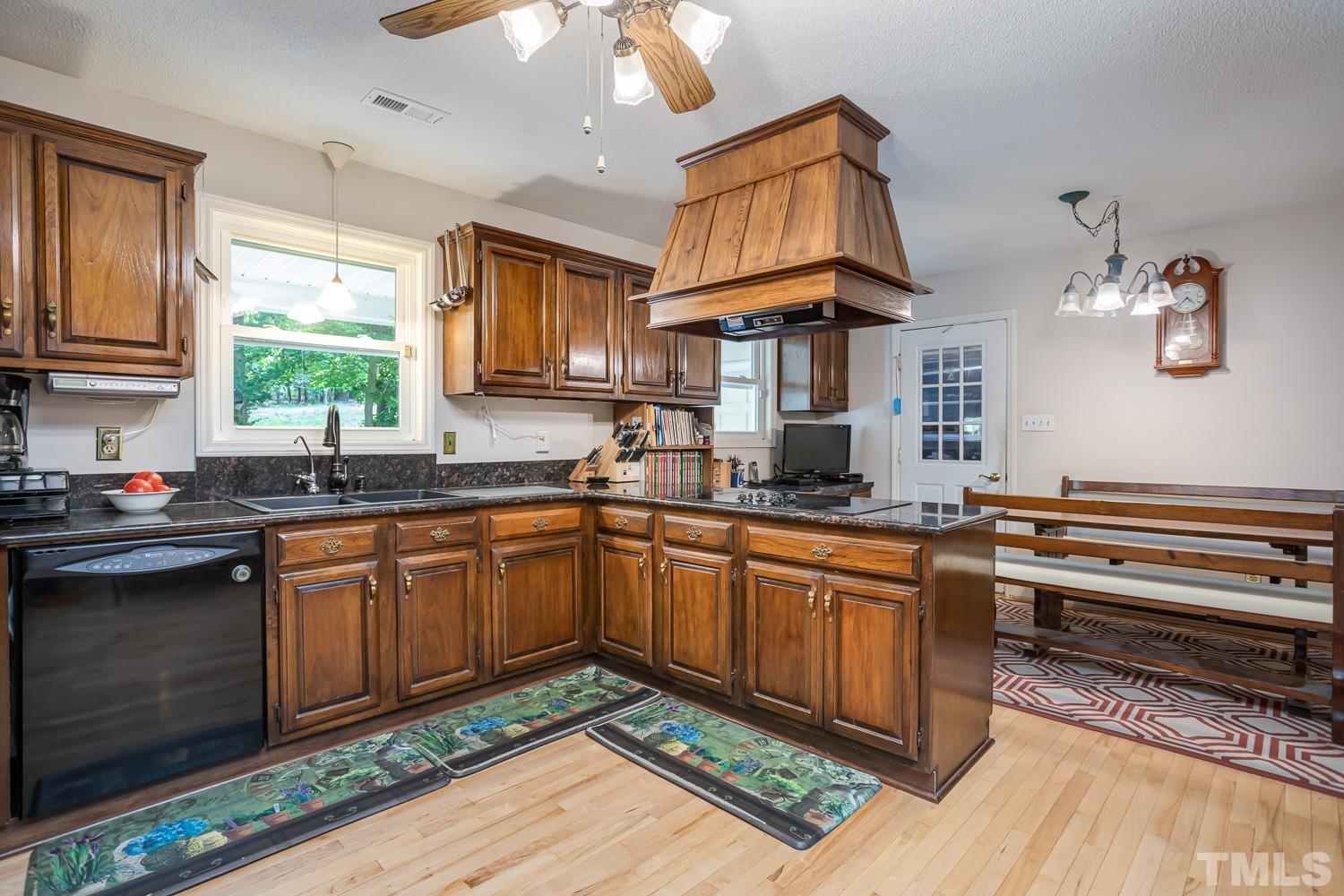14401 Possum Track Road Raleigh, NC 27614 - Photo 6 of 30 a kitchen with stainless steel appliances granite countertop a sink a stove cabinets counter space and a window