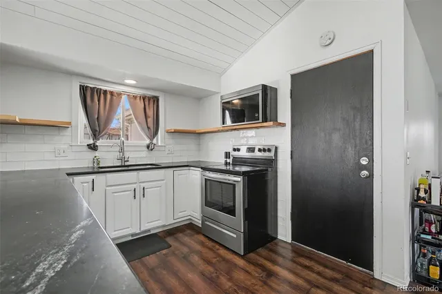 a kitchen with stainless steel appliances granite countertop a stove and a refrigerator