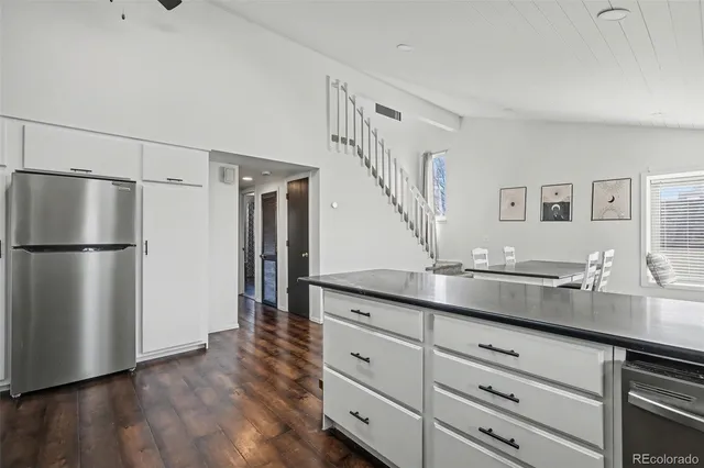 a kitchen with a refrigerator and a sink