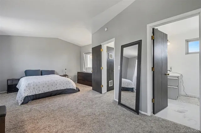 a spacious bedroom with a bed and walk in closet