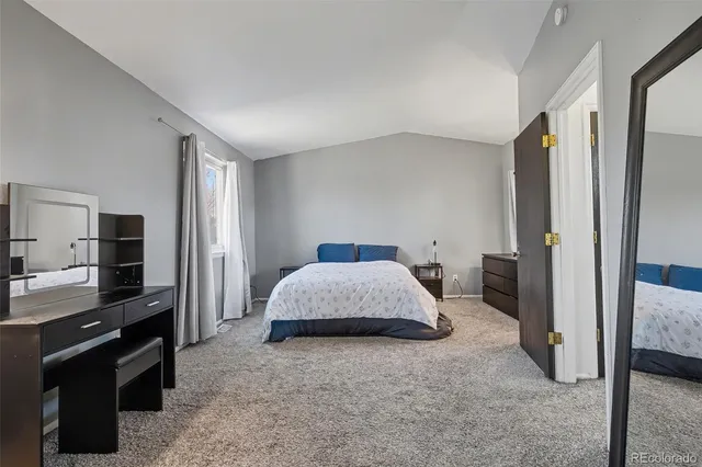 a spacious bedroom with a bed and a walk in closet