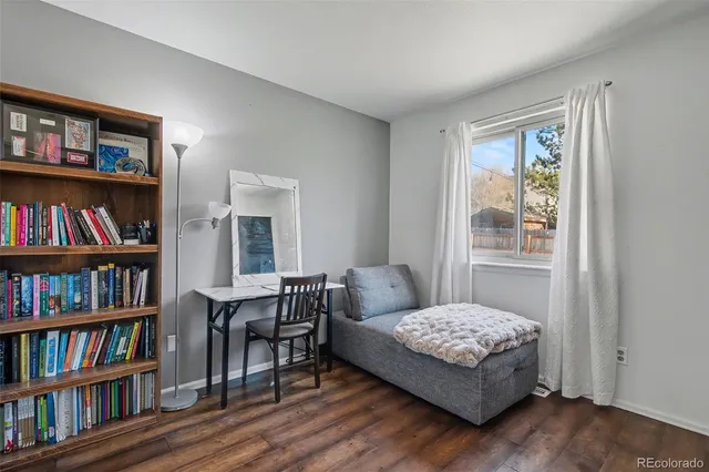 a bedroom with a bed and a book shelf