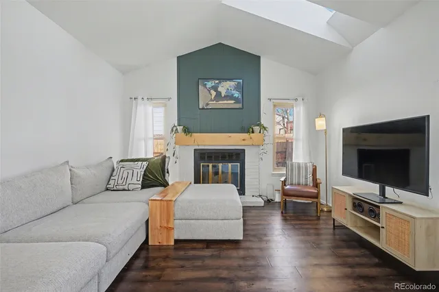 a living room with furniture fireplace and flat screen tv