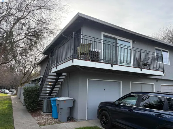 a view of backyard with deck and outdoor seating