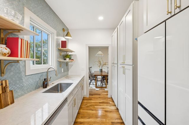 a living room with fireplace furniture and a chandelier