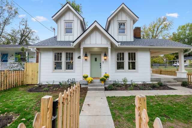 a view of staircase with railing and a rug