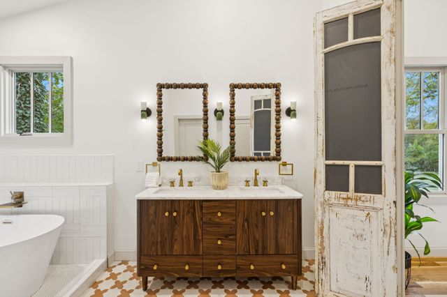 a view of a dinning table and chairs in patio of the house