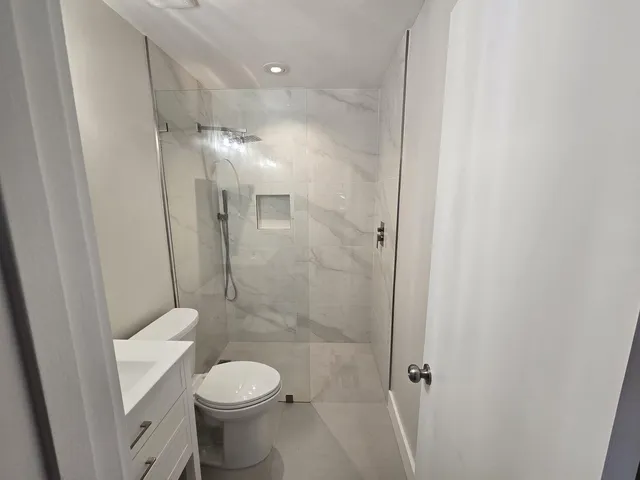 a bathroom with a sink toilet and shower