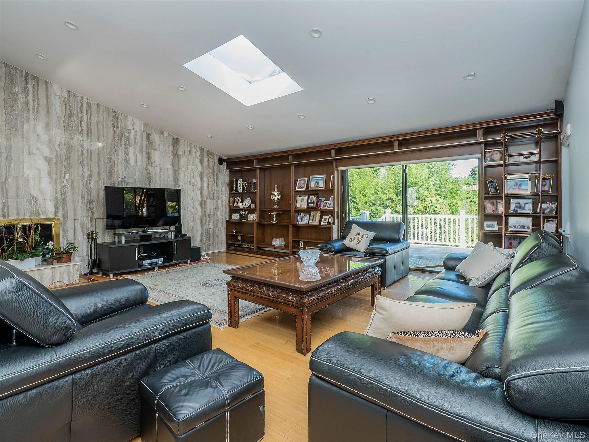 32 Carriage Road Great Neck, NY 11024 - Photo 14 of 33 a living room with furniture and a flat screen tv