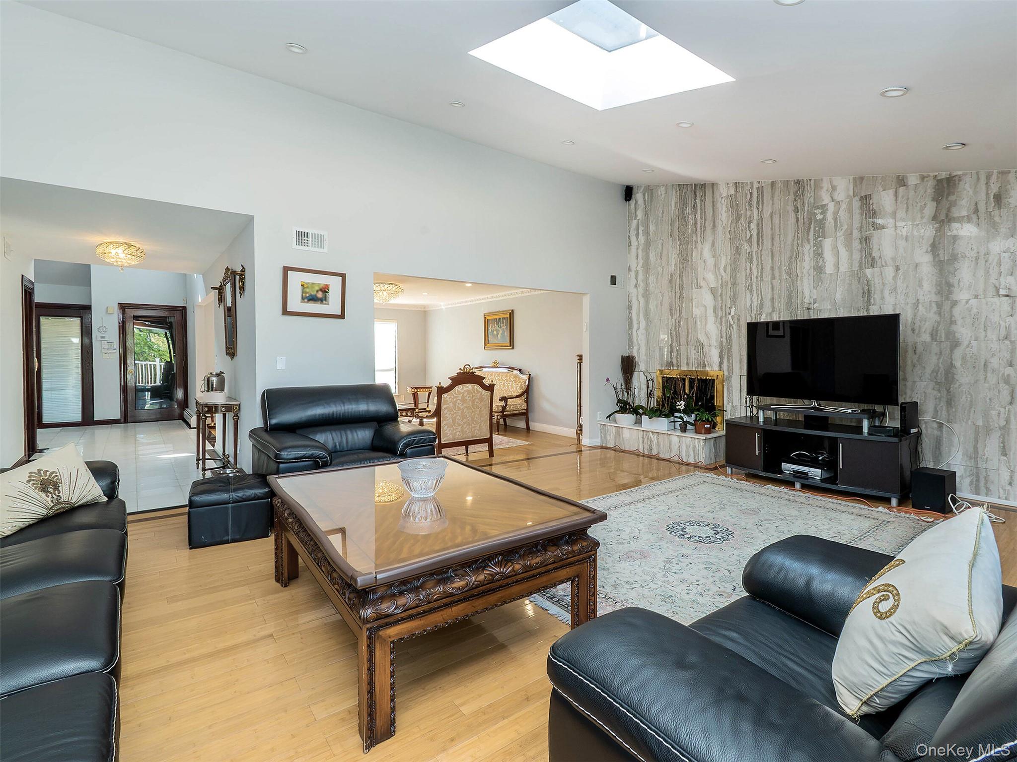 32 Carriage Road Great Neck, NY 11024 - Photo 15 of 33 a living room with furniture and a flat screen tv