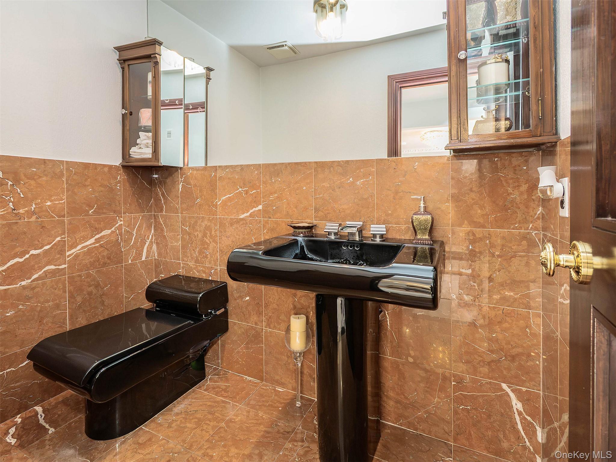 32 Carriage Road Great Neck, NY 11024 - Photo 16 of 33 a bathroom with a sink and a mirror