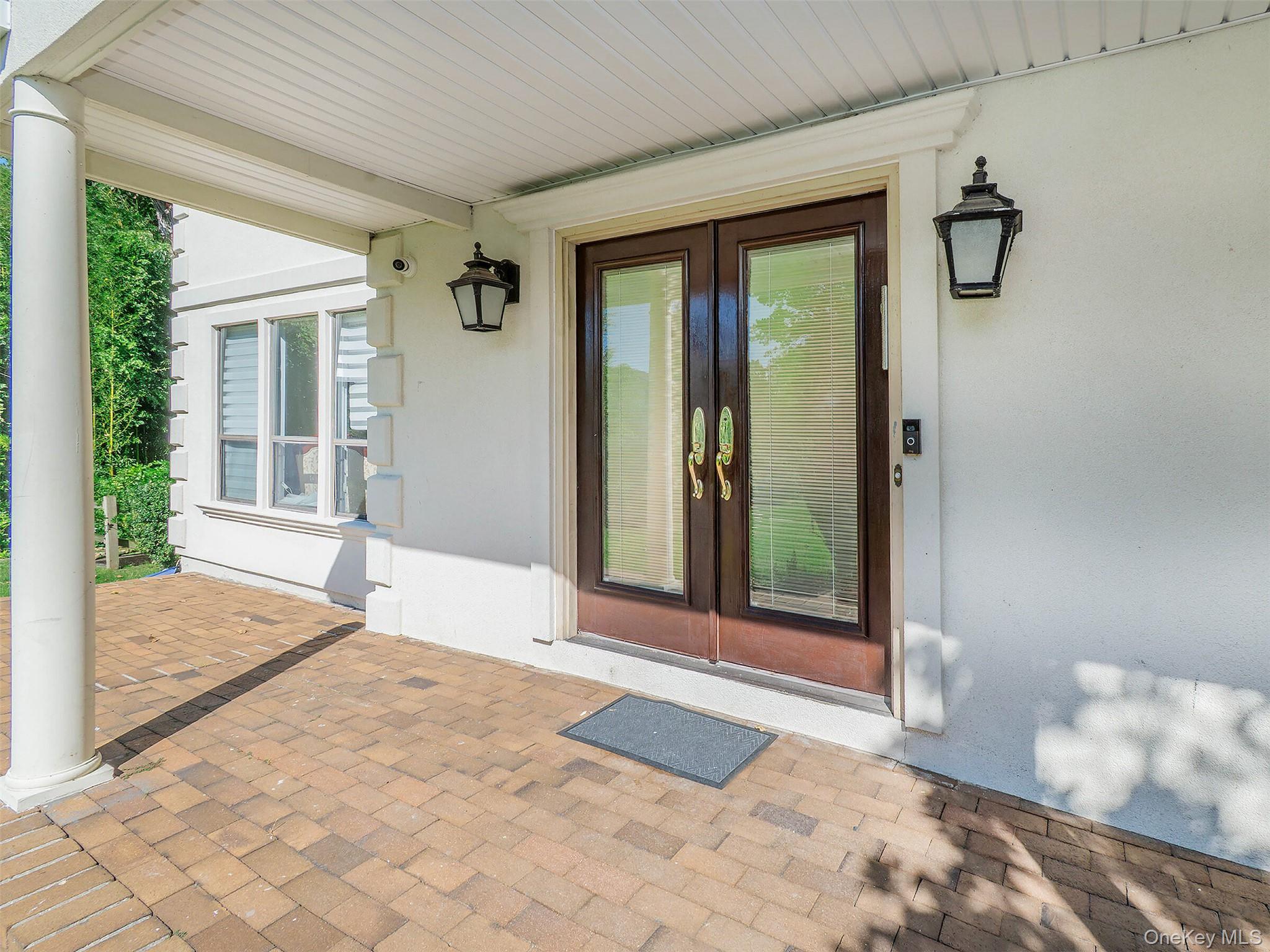 32 Carriage Road Great Neck, NY 11024 - Photo 2 of 33 a bedroom with a bed and a window