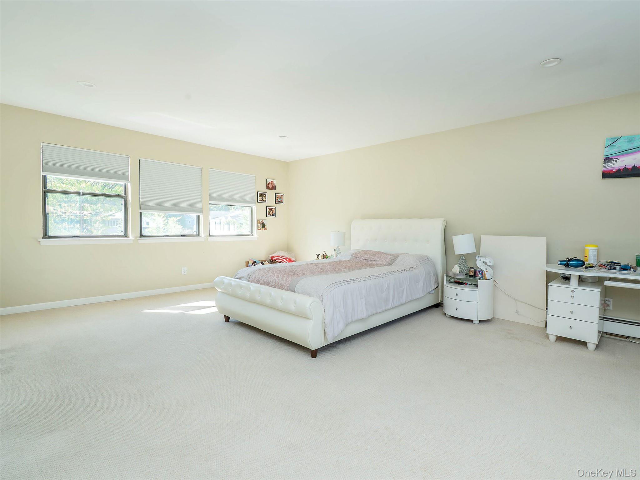 32 Carriage Road Great Neck, NY 11024 - Photo 23 of 33 a bedroom with a bed and window