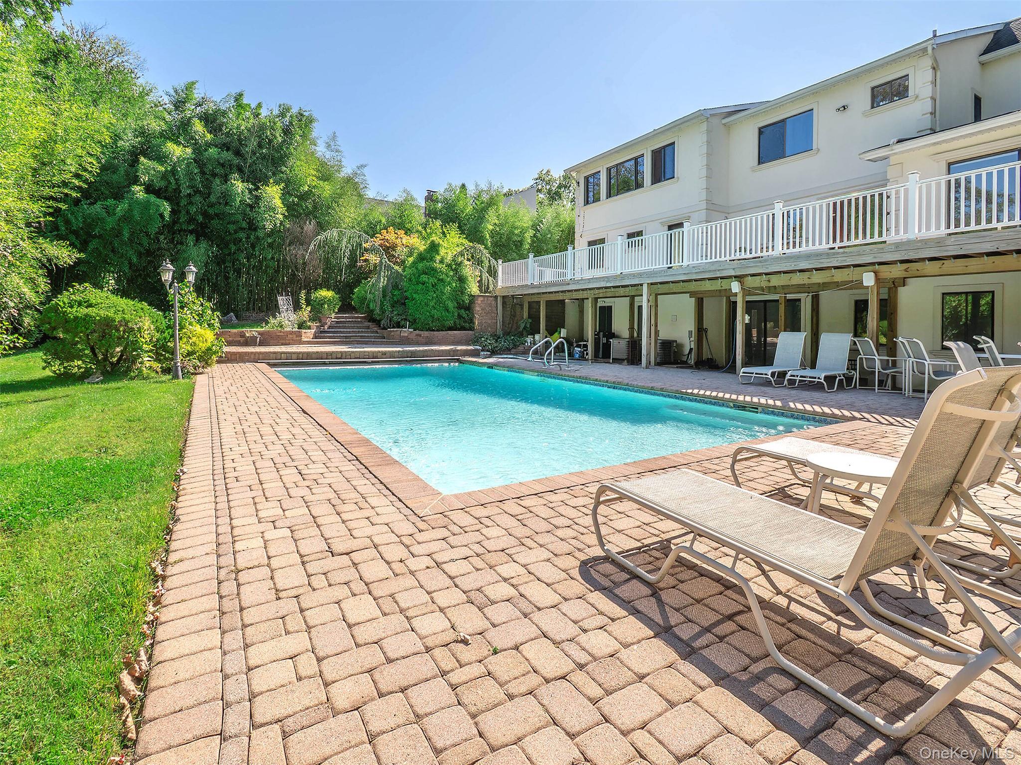 32 Carriage Road Great Neck, NY 11024 - Photo 25 of 33 a view of a house with backyard porch and sitting area