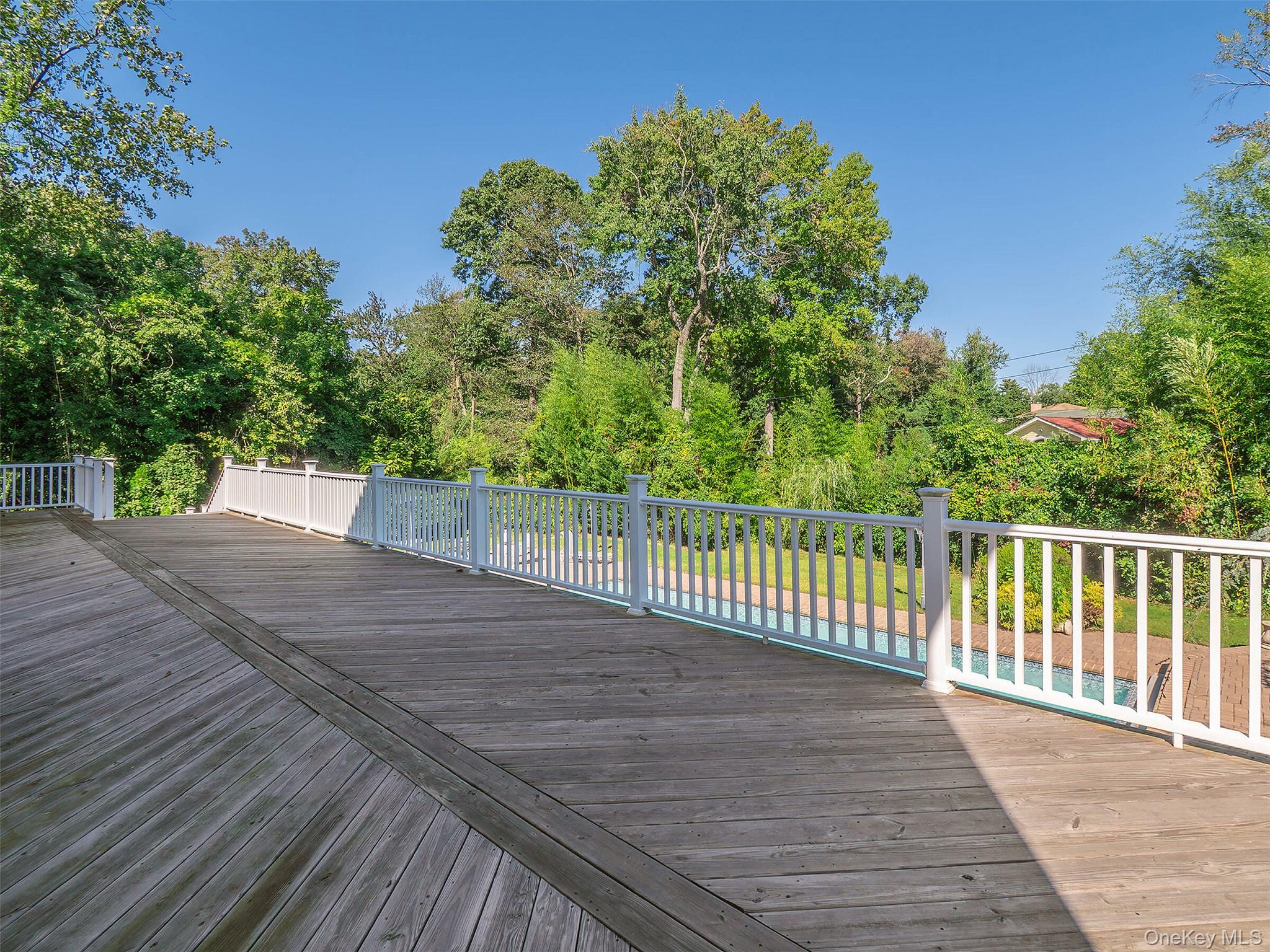 32 Carriage Road Great Neck, NY 11024 - Photo 26 of 33 a view of a backyard with a wooden fence