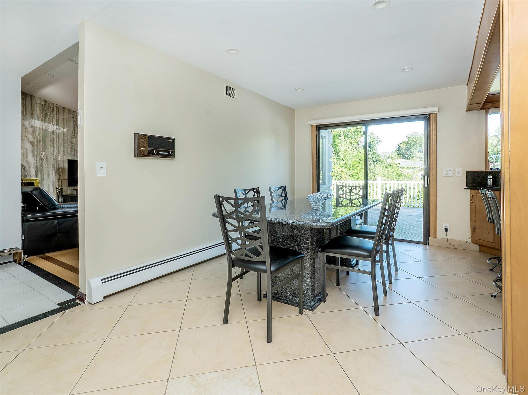 32 Carriage Road Great Neck, NY 11024 - Photo 8 of 33 a view of a dining room with furniture and a potted plant
