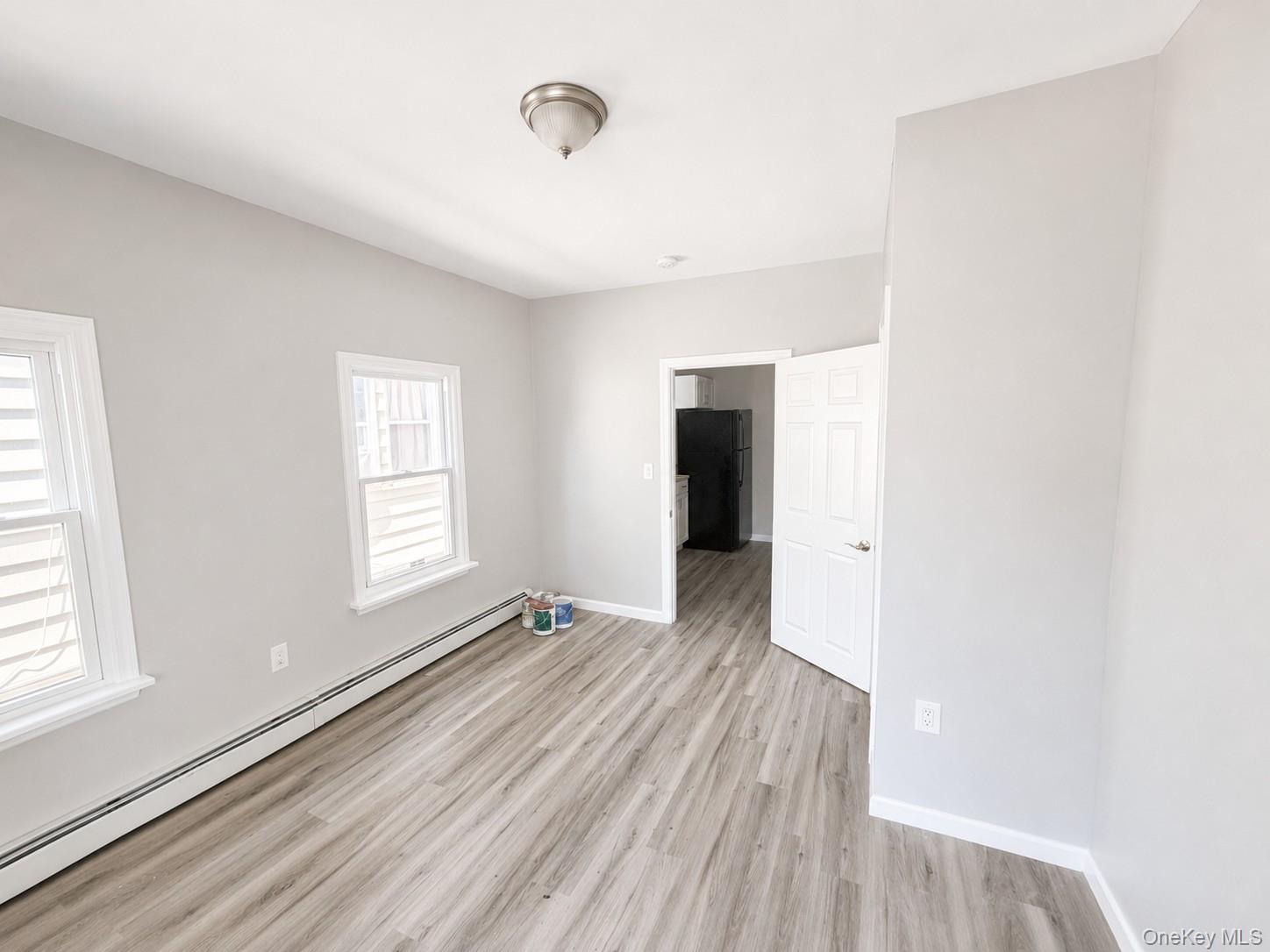 25 Monroe Street, Unit 1 Mount Vernon, NY 10550 - Photo 7 of 11 Bedroom featuring wood-finish flooring, light gray wall tones, and white baseboards