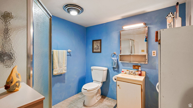 44 Shriver Street Eureka, UT 84628 - Photo 13 of 43 Bathroom featuring a glass-enclosed shower, a white toilet, and a vanity with a sink and storage