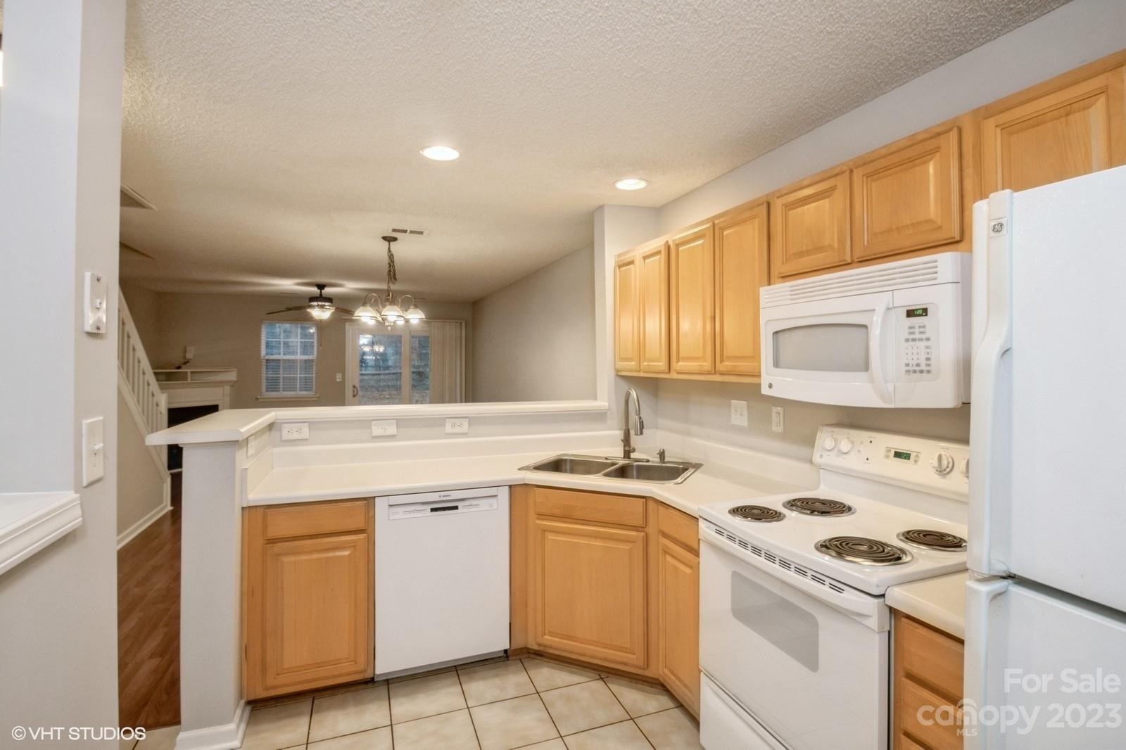 a kitchen with a stove a sink and a refrigerator