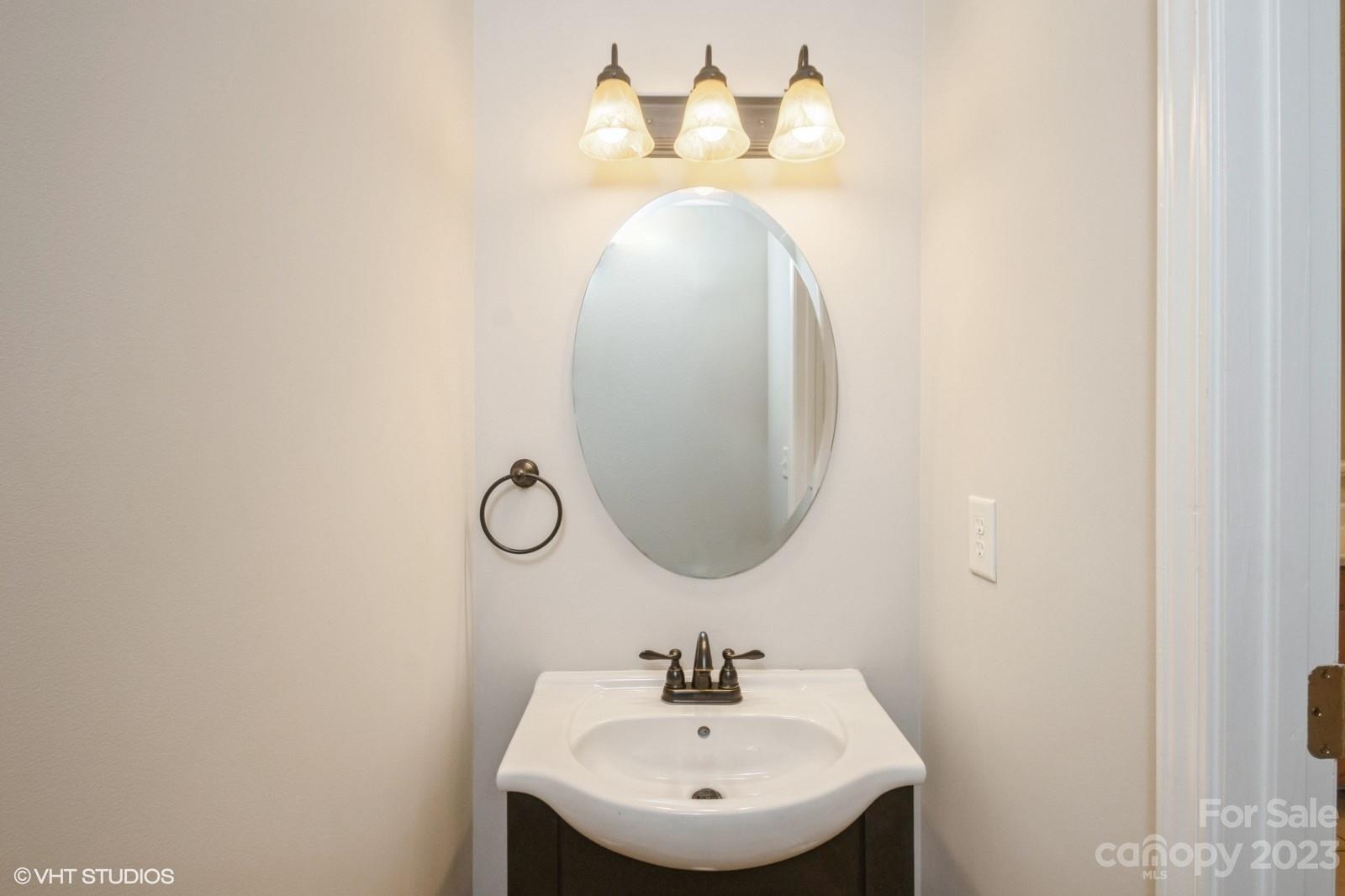 8334 Rudolph Road Charlotte, NC 28216 - Photo 11 of 31 a bathroom with a sink and a mirror