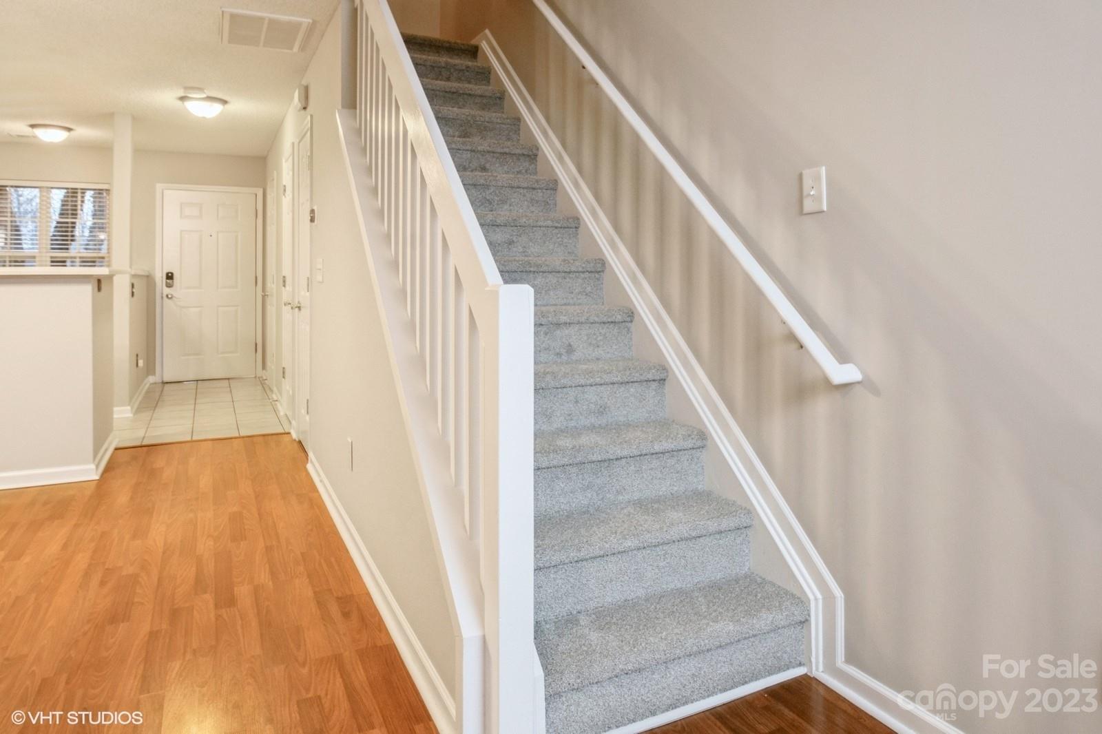 8334 Rudolph Road Charlotte, NC 28216 - Photo 15 of 31 a view of a hallway with wooden floor and staircase