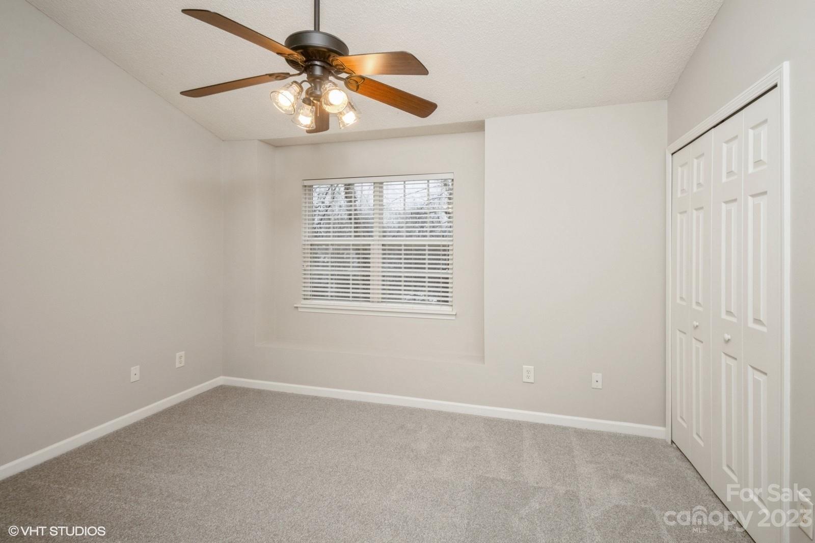 8334 Rudolph Road Charlotte, NC 28216 - Photo 17 of 31 an empty room with windows and fan