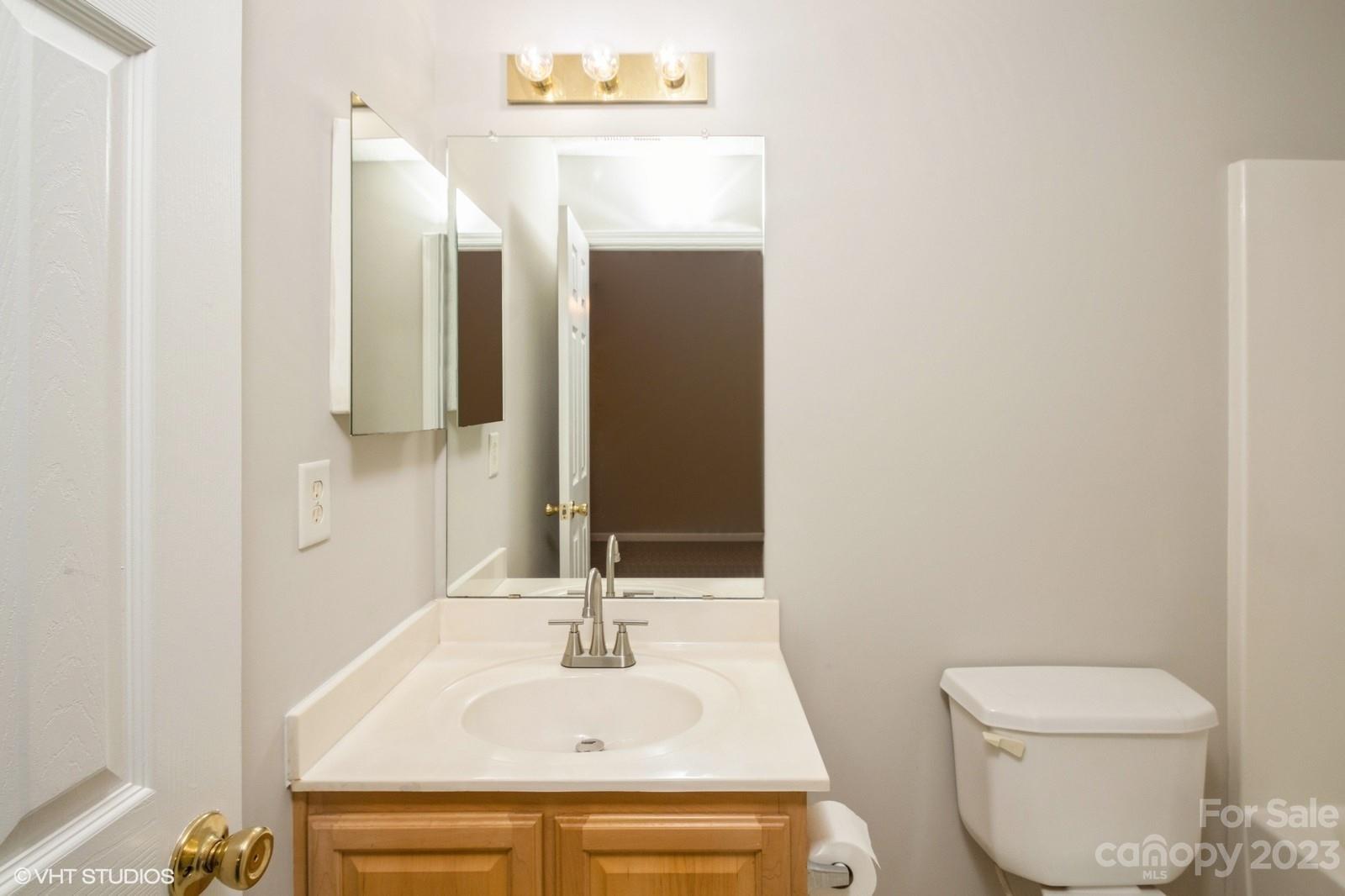 8334 Rudolph Road Charlotte, NC 28216 - Photo 21 of 31 a bathroom with a sink and a mirror