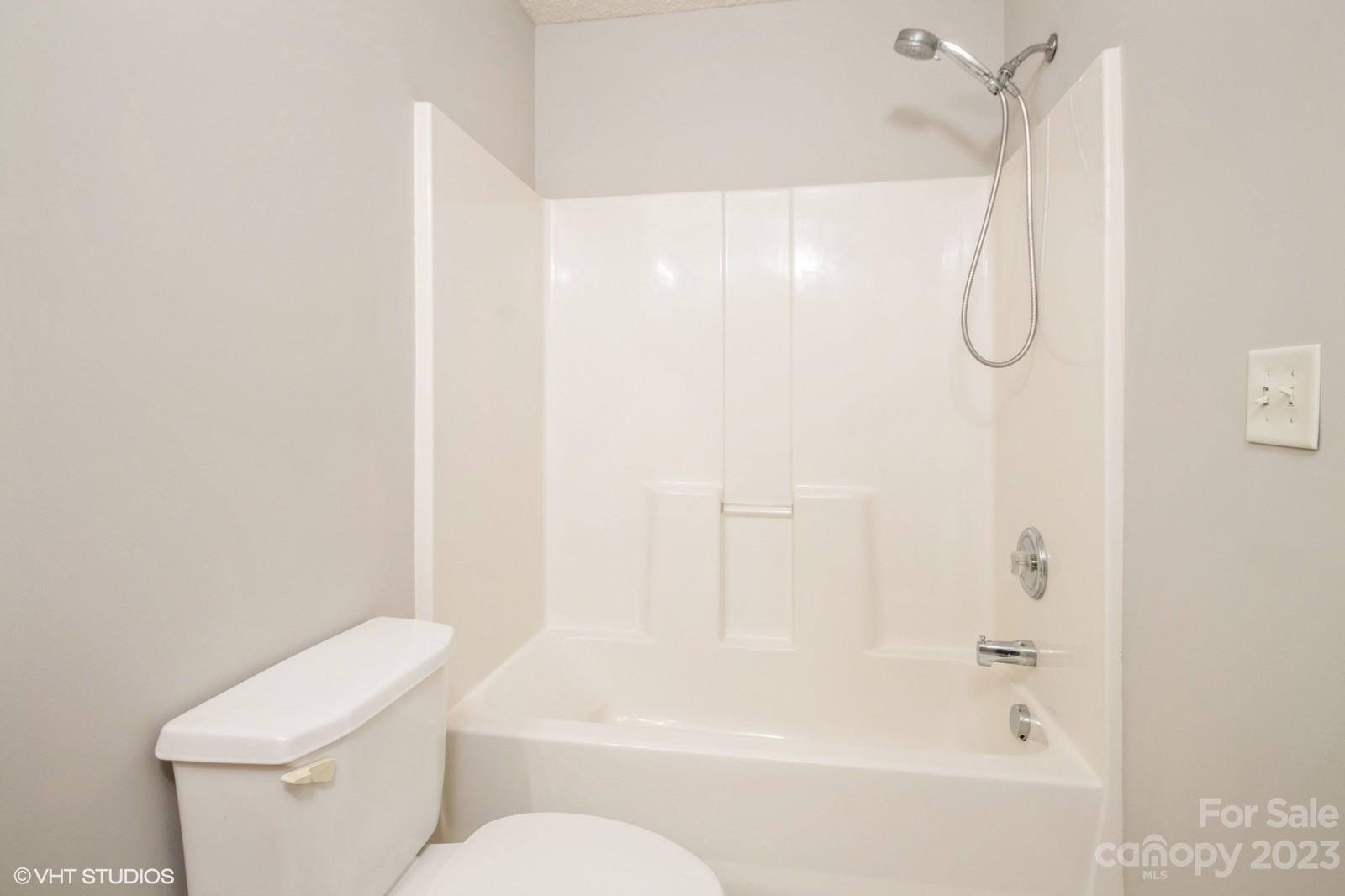 8334 Rudolph Road Charlotte, NC 28216 - Photo 22 of 31 a bathroom with a granite countertop bathtub shower and toilet