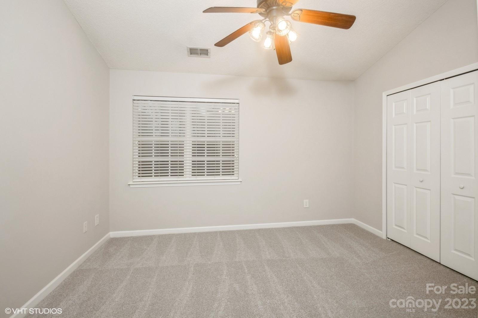8334 Rudolph Road Charlotte, NC 28216 - Photo 23 of 31 an empty room with windows and fan