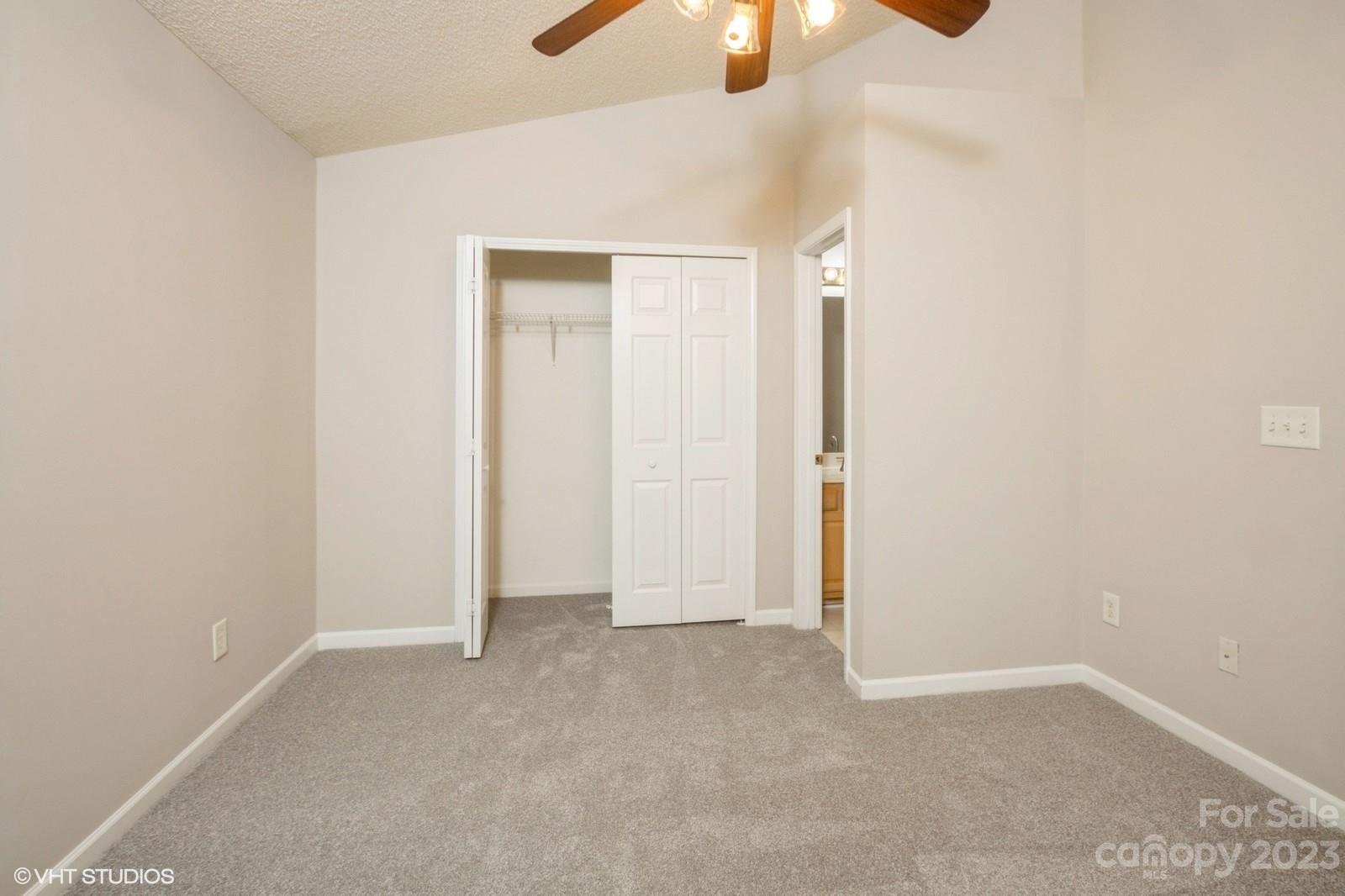 8334 Rudolph Road Charlotte, NC 28216 - Photo 24 of 31 an empty room with closet and chandelier fan