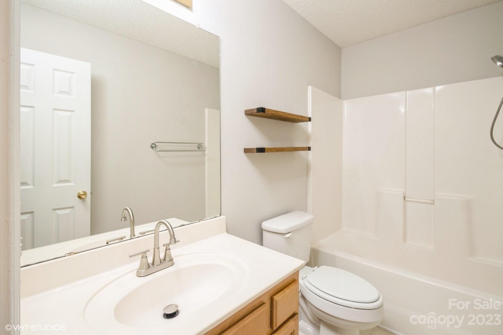 8334 Rudolph Road Charlotte, NC 28216 - Photo 26 of 31 a bathroom with a sink toilet and shower