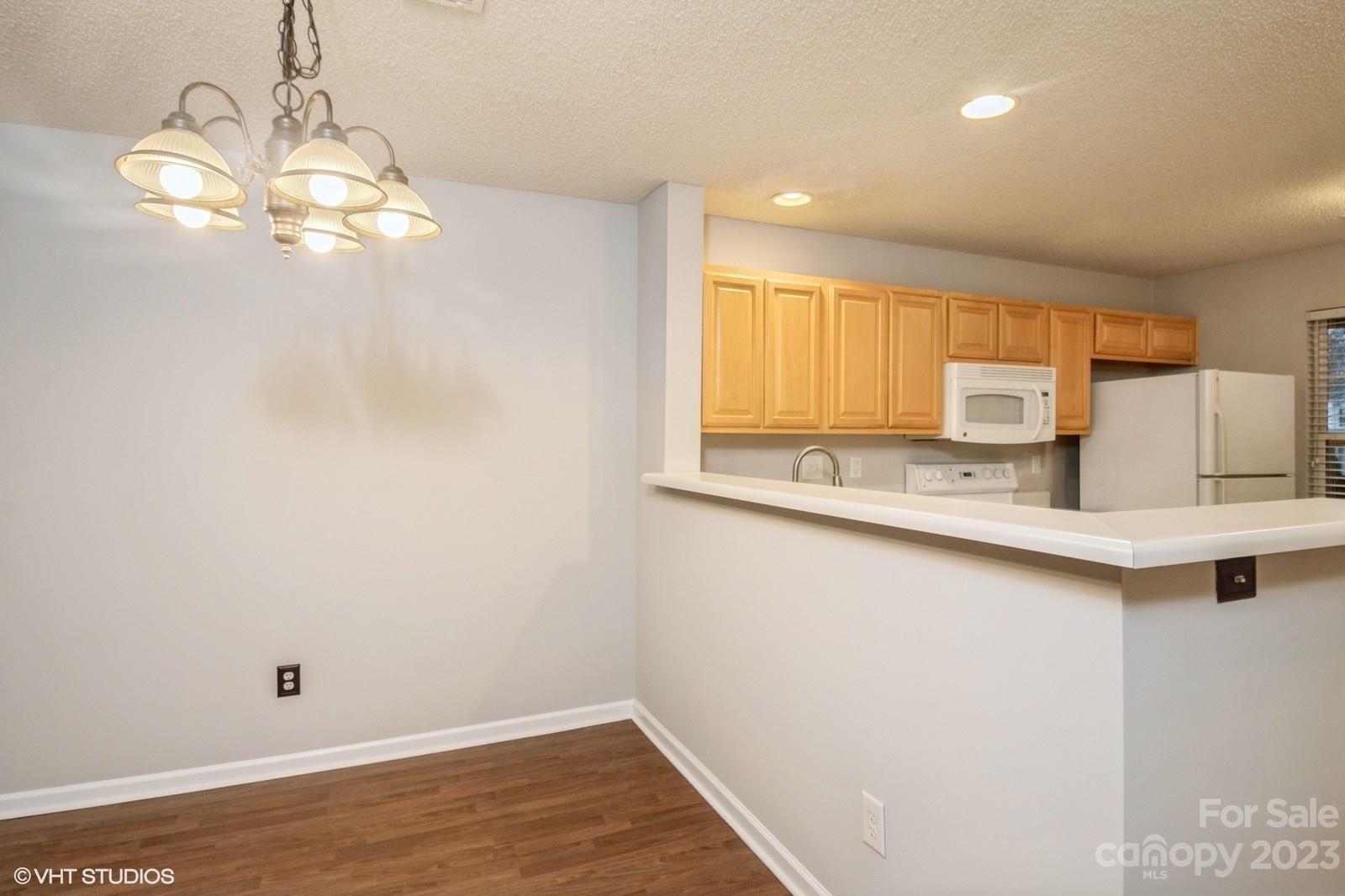 8334 Rudolph Road Charlotte, NC 28216 - Photo 5 of 31 a view of a kitchen with wooden floor and a window